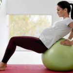 side-view-young-pregnant-woman-exercising-fitness-ball